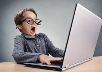 Shocked and surprised boy on the Internet with laptop computer