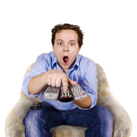 Man holding several TV remotes